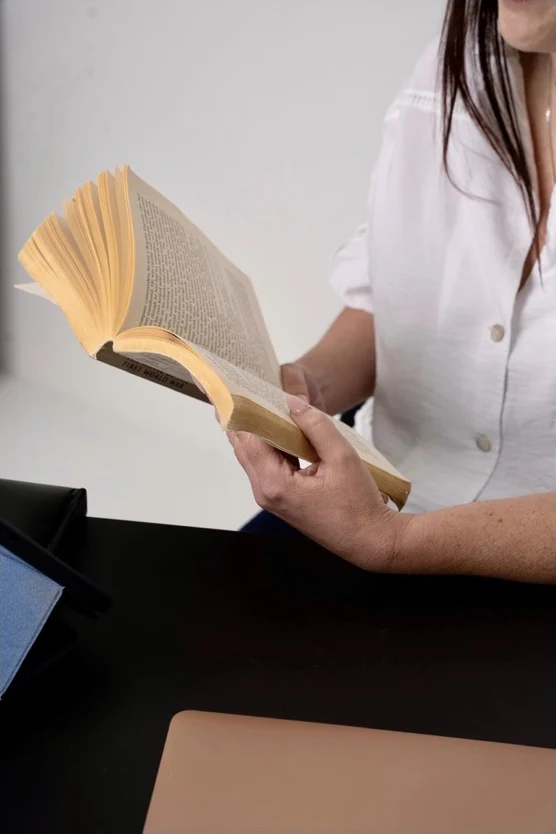 Reading a novel at a desk